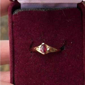 Gold and Ruby Ring with small Diamonds on each side. Size 6.